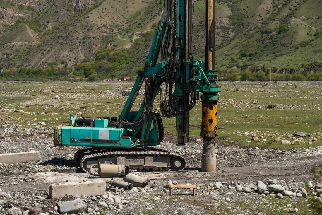 A heavy drill rig at work on an open outdoor site