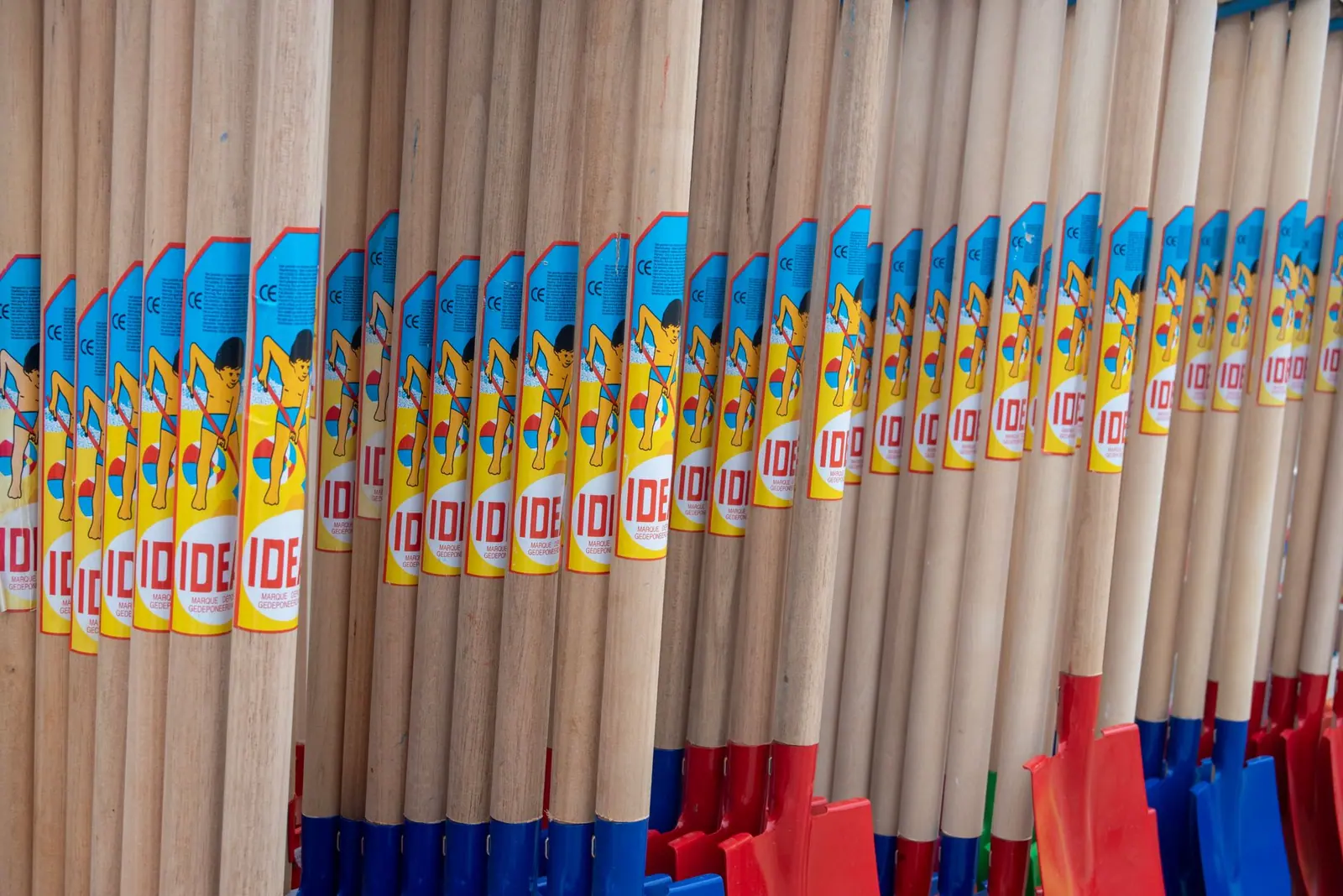 Rows of tool handles with printed price labels along a store display
