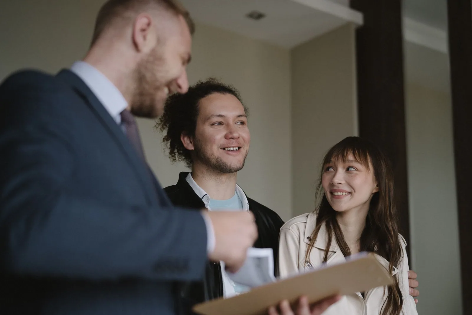 A couple talking with a sales representative across a table at home