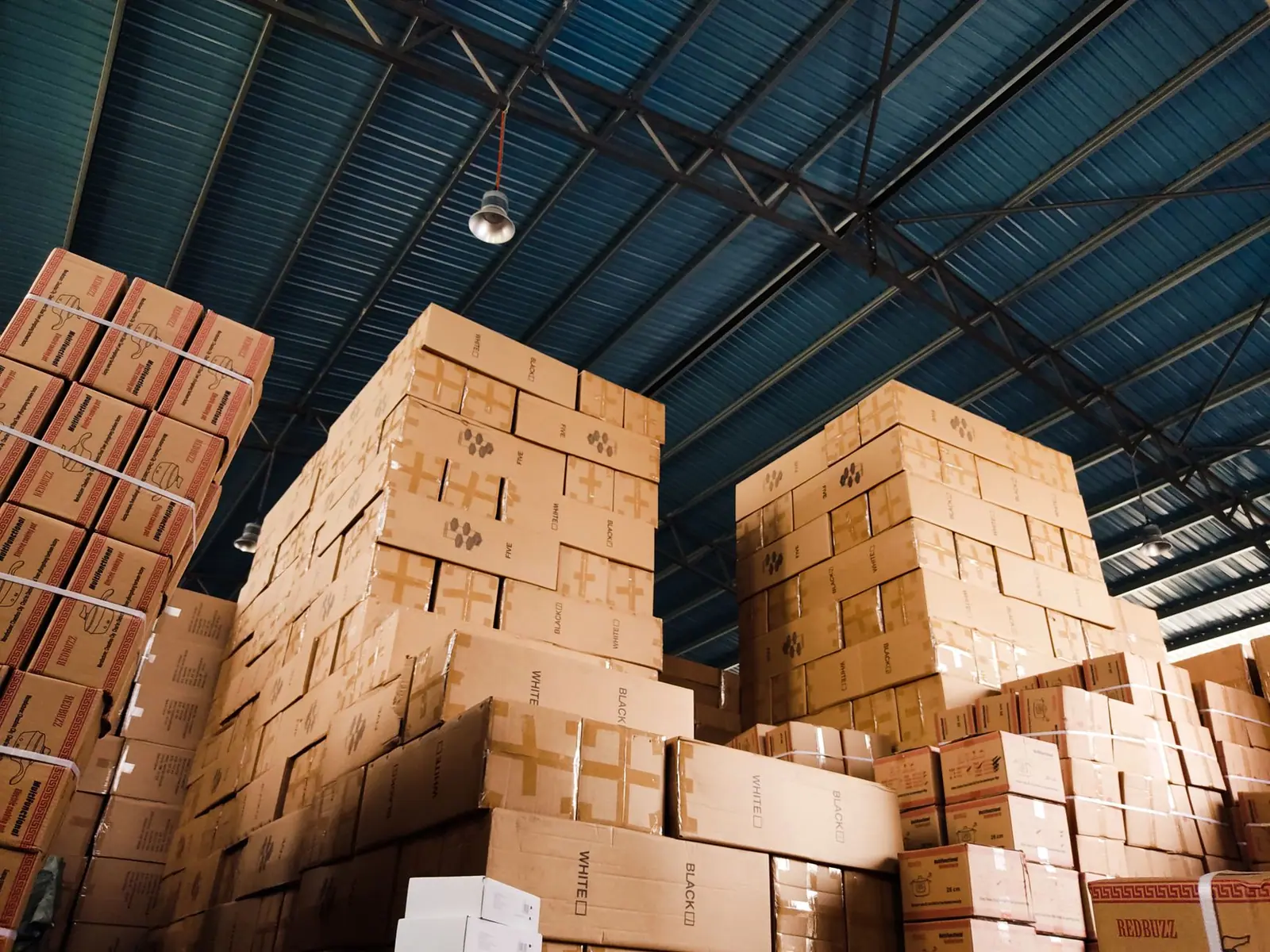 High stacks of cardboard boxes on warehouse shelving