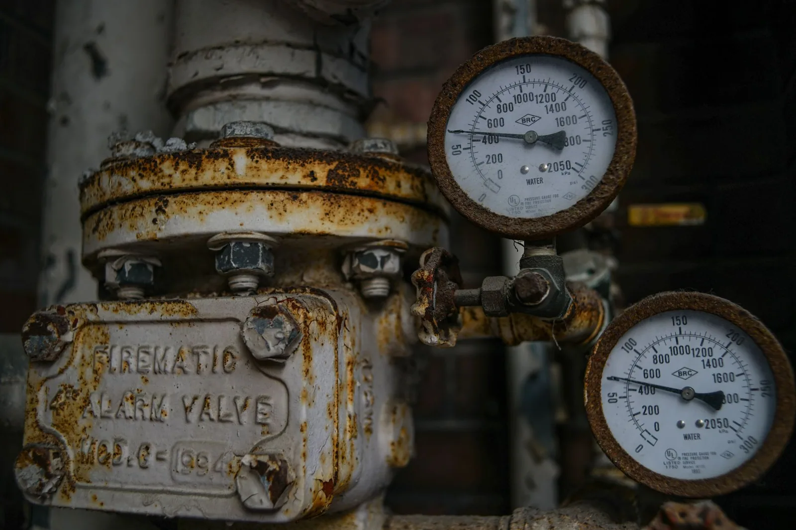 A rusted water valve and its two pressure gauges after decades in service