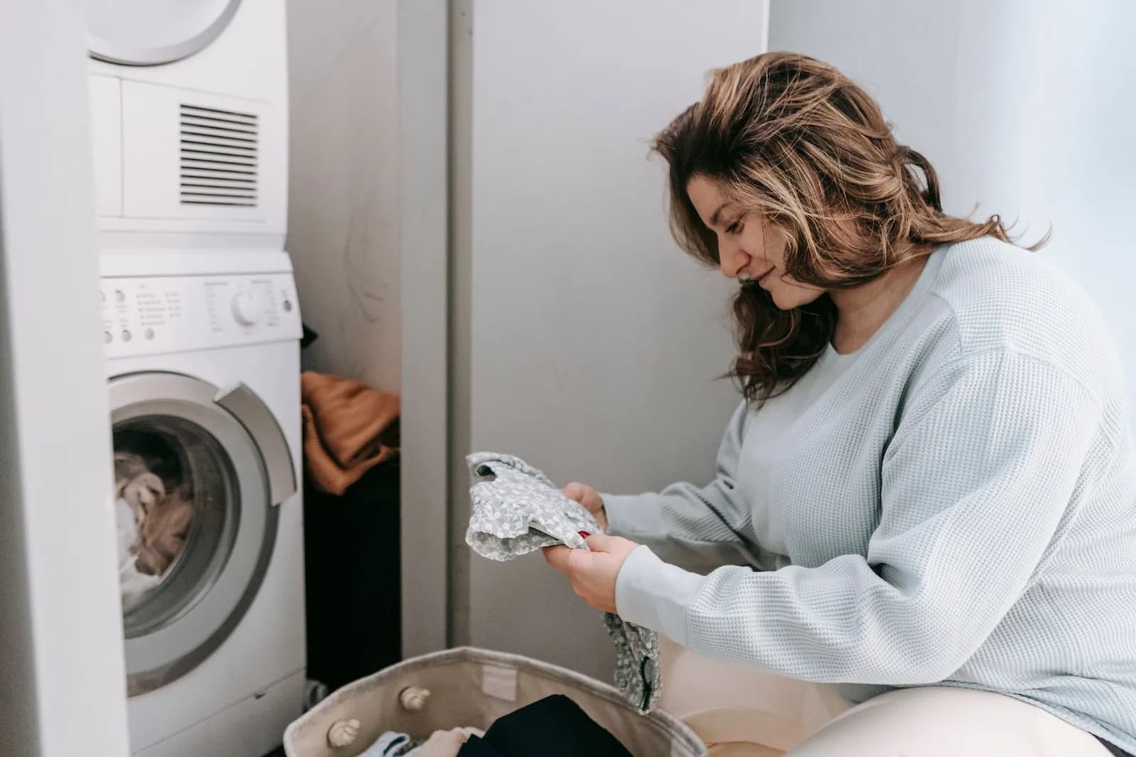Laundry room work, where a failing softener shows up as stiff towels and grey whites