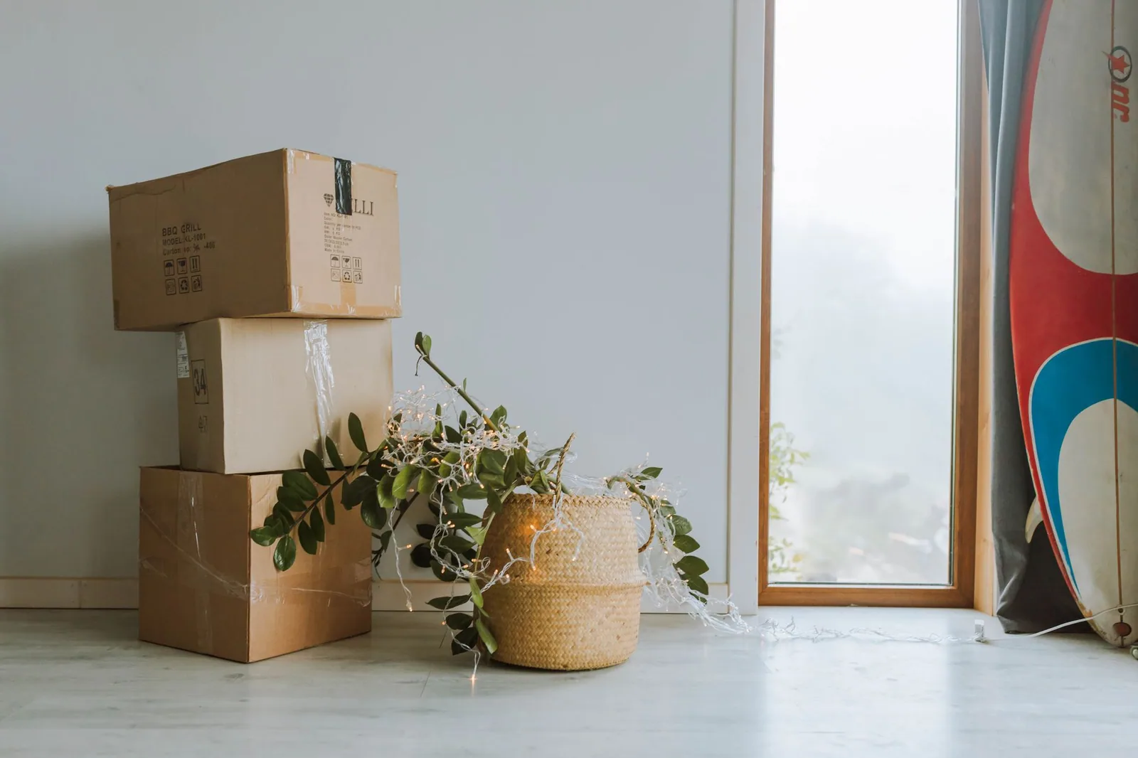 Cardboard cartons stacked by a window after a direct to consumer delivery