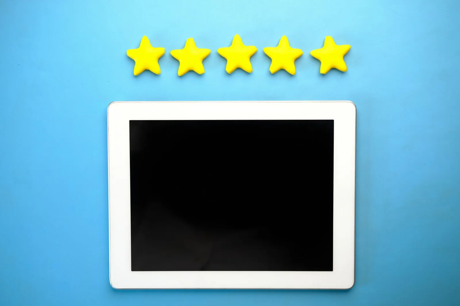 Five yellow stars lined up above a blank tablet screen
